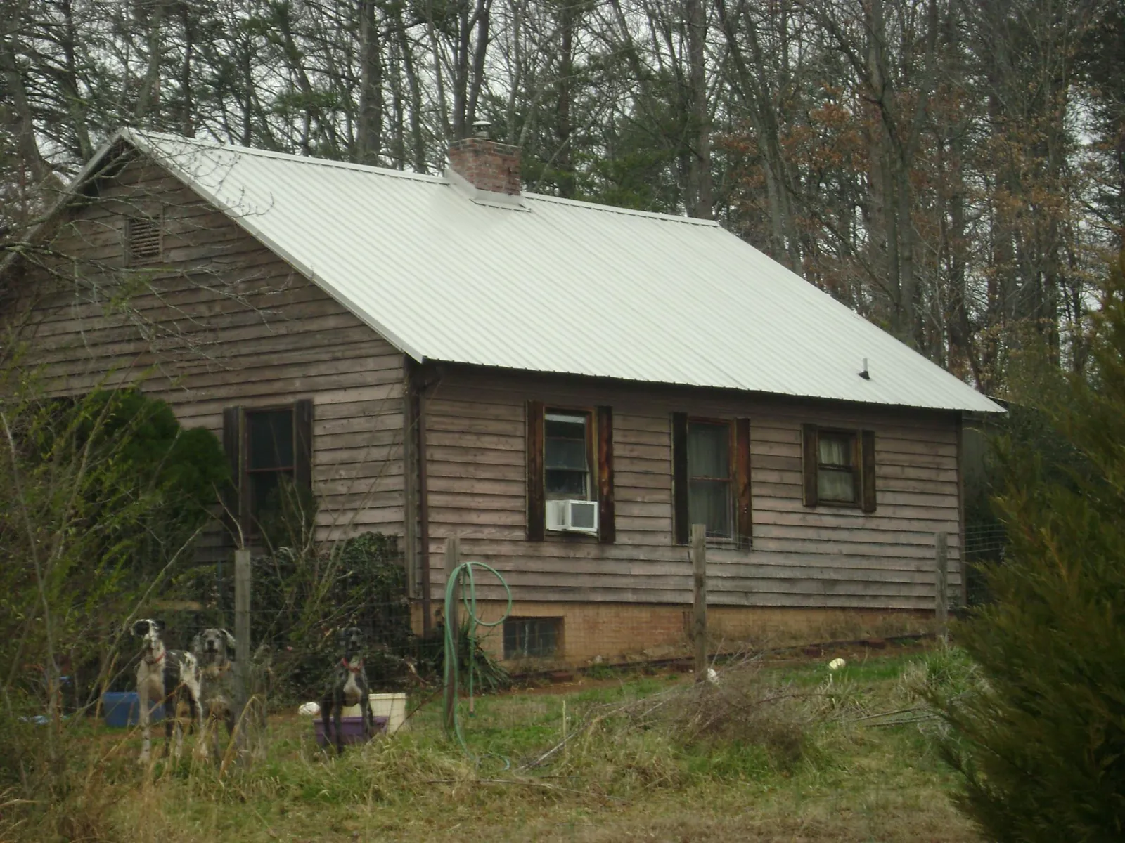 White metal roof on an old wood sided farmhouse, from a Metal Roof Installation job in South Glens Falls